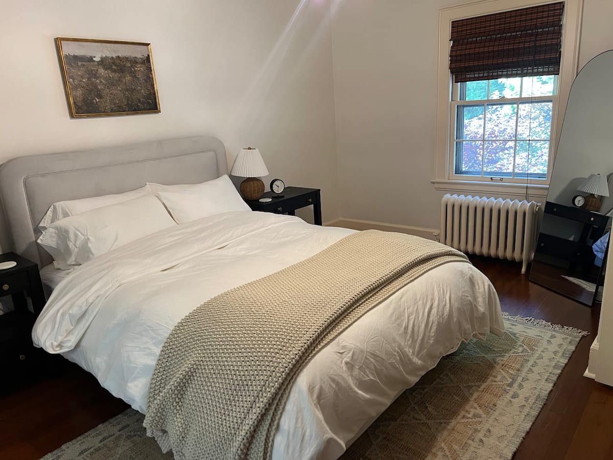 A restful queen bedroom with soft neutral bedding